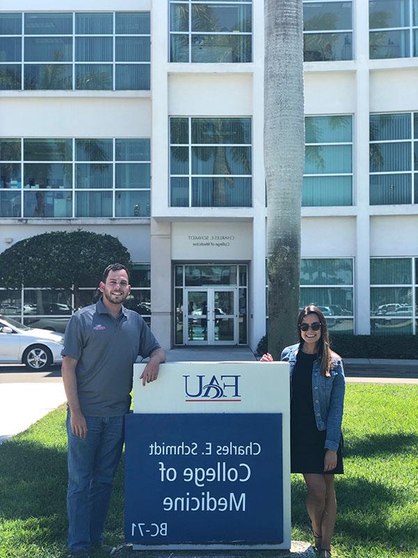 Dr. Kenan Ashouri and Dr. Annie Lopez-Ashouri in front of Schmidt College of Medicine building at Boca Raton